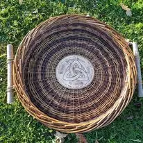 Round willow tray with patterned centre, photographed outdoors